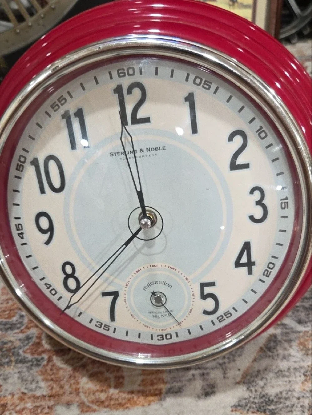 This is a retro-style decorative wall clock made by Sterling & Noble.